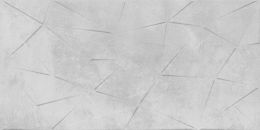 Szara matowa płytka imitująca geometryczne trójkątne uwypuklenia wystające  z cementowej powierzchni